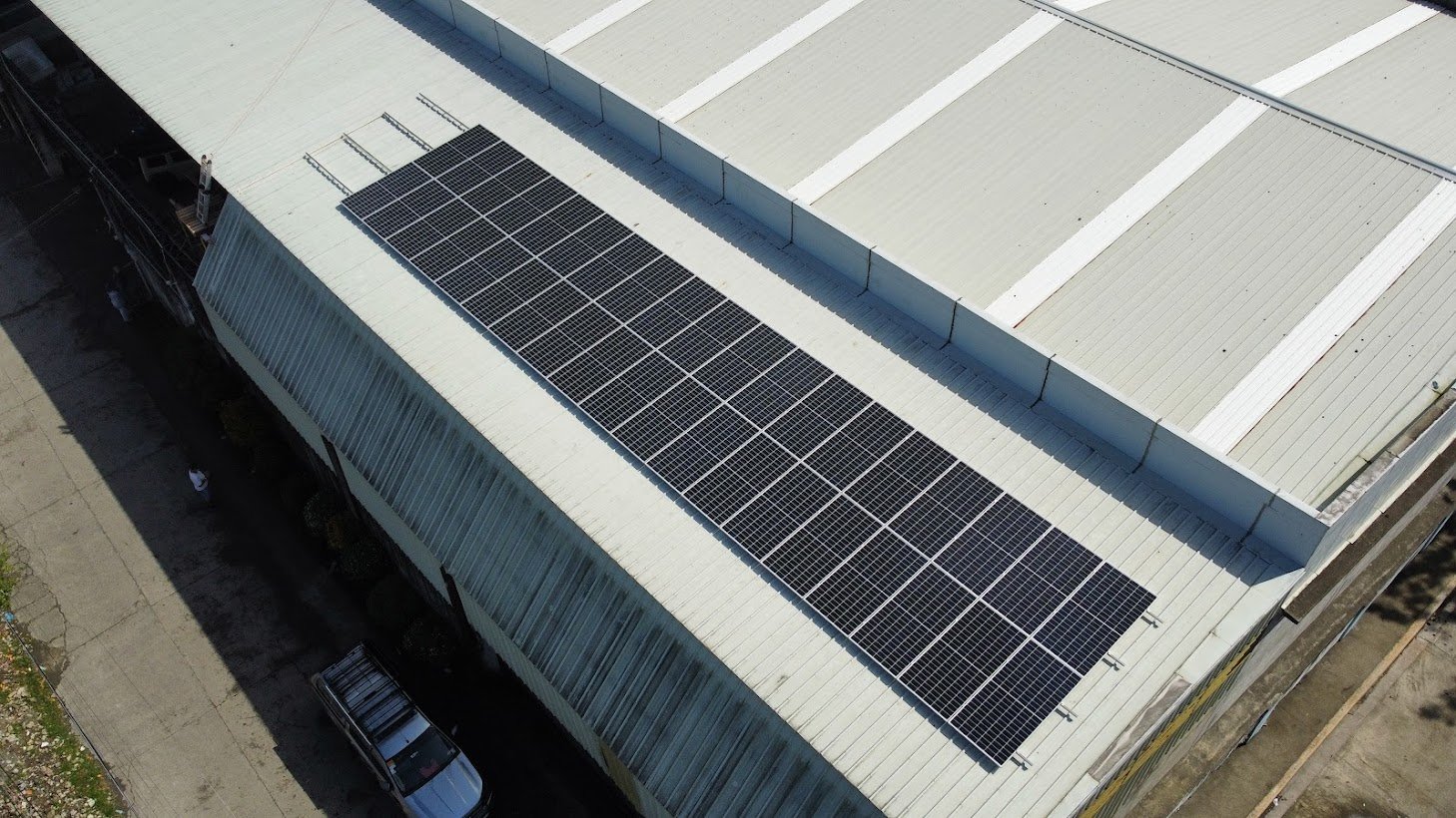 Aerial view of solar panels on a large rooftop